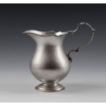 A rare George II Channel Islands silver cream jug, maker's mark PM struck three times to base (