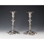 A fine pair of George II period Channel Islands silver rococo candlesticks, maker's mark GH struck