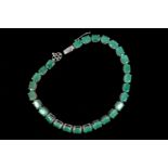 Emerald Set Bracelet of Twenty Seven Oval Cut Emeralds Silver Mounted with Open Form Decorated Clasp