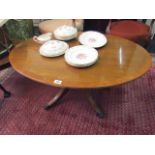 Oval Form Satinwood Coffee Table Crossbanded on Quatrefoil Supports with Brass Paw Casters