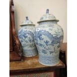 Pair of Oriental Blue and White Vases with Lidded Tops Fo Dog Motif Surmounts Each 24 Inches High