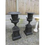 Pair of Cast Iron Garden Urns on Pedestal Bases with Decorated Panels Each 44 Inches High