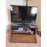 Modern Television Set Flatscreen Samsung with Remote Controls and DVD Player and Cabinet Rest