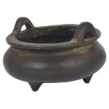 A CHINESE BRONZE CENSER, QING DYNASTY, 17TH / 18TH CENTURY the compressed globular body on three