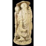 ˜A JAPANESE IVORY OKIMONO OF FISHERMEN, MEIJI PERIOD (1868-1912) carved as a figure wading through