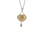 PERIDOT PENDANT, 1900s designed as a pair of interlocking reeded circlets mounted with an oval