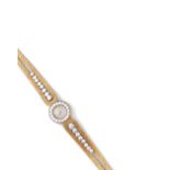 LADY'S EIGHTEEN CARAT GOLD AND DIAMOND WATCH, PIAGET, 1960s the cream dial with gold batons and