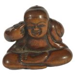 A JAPANESE WOOD NETSUKE OF A BOY DOING BEKKAKO, LATE EDO PERIOD, CIRCA 1860 seated with his tongue