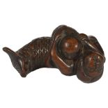 A JAPANESE WOOD NETSUKE OF A NURSING MERMAID, EDO PERIOD, CIRCA 1790 a characterful old carving,