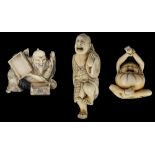 ˜A GROUP OF THREE JAPANESE IVORY NETSUKE, MEIJI PERIOD (1868-1912) comprising: a study of Daruma,