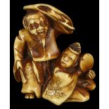 ˜A JAPANESE STAINED IVORY NETSUKE OF ENTERTAINERS BY ONO RYOMIN, EARLY MEIJI PERIOD, CIRCA 1870 an