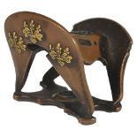 A JAPANESE COPPER NETSUKE OF A SADDLE, LATE EDO PERIOD, CIRCA 1860 with applied gilt kiri-mon,