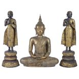 A LACQUERED GILT BRONZE FIGURE OF BUDDHA WITH TWO ASSOCIATED FIGURES OF DEVOTEES, RATNAKOSIN,