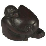 A JAPANESE WOOD NETSUKE OF A MONKEY HUGGING A HUGE PEACH, LATE EDO PERIOD, CIRCA 1830 originally