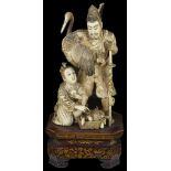 ˜A JAPANESE IVORY OKIMONO OF AN ARCHER, MEIJI PERIOD, LATE 19TH CENTURY carved standing with a heron