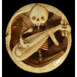 ˜A JAPANESE IVORY MANJU NETSUKE OF A SKELETON PLAYING A BIWA, EARLY MEIJI PERIOD, CIRCA 1870