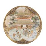 A JAPANESE SATSUMA PLATE, MEIJI PERIOD (1868-1912) painted with figures in a garden before a