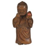 A JAPANESE BOXWOOD NETSUKE OF A BOY DOING BEKKAKO, LATE EDO PERIOD, CIRCA 1820 an unusual variant,