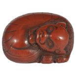 A JAPANESE RED LACQUER NETSUKE OF A SHISHI, LATE EDO PERIOD, CIRCA 1800 in Chinese style, curled