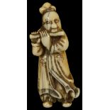 ˜A JAPANESE STAINED IVORY NETSUKE OF A CHINESE SCHOLAR, LATE EDO PERIOD, CIRCA 1820 playing a flute,