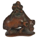 A JAPANESE WOOD NETSUKE OF A HERD-BOY ON AN OX, LATE EDO PERIOD, CIRCA 1850 with a basket on his