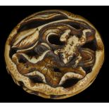 ˜A JAPANESE STAINED IVORY MANJU NETSUKE OF A FROG AND LOTUS, EARLY MEIJI PERIOD, CIRCA 1870 the frog