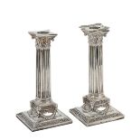 A PAIR OF VICTORIAN SILVER CANDLESTICKS, MARTIN, HALL & CO. LTD., LONDON, 1891 the square bases with