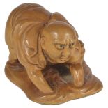 A JAPANESE PALE BOXWOOD NETSUKE OF A CLAM FISHERMAN, MEIJI PERIOD, CIRCA 1900 knee deep in water,