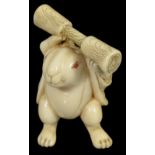 ˜A JAPANESE IVORY NETSUKE OF THE LUNAR HARE, LATE EDO PERIOD, CIRCA 1850 standing in a haori (