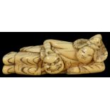 ˜A JAPANESE IVORY NETSUKE OF A BUGAKU DANCER, EDO PERIOD, CIRCA 1790 lying in his robes and hat,