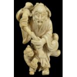 ˜A JAPANESE IVORY NETSUKE OF A CHINESE SAGE AND BOY, LATE EDO PERIOD, CIRCA 1850 the man dancing