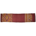 A WOVEN SILK SHAWL, LAOS, 19TH CENTURY of long rectangular form, the plain crimson ground with