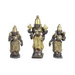 A ‘GANGAJUMNA’ VISHNU TRIO, SOUTH INDIA, CIRCA 18TH CENTURYbronze and brass, comprising a four-armed