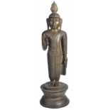 A BRONZE FIGURE OF BUDDHA, SRI LANKA, 19TH CENTURYstanding on a waisted circular base, his hands