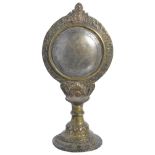 A BRONZE MIRROR, NEPAL, CIRCA 18TH CENTURYof circular form, the tinned convex surface disc set