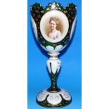 A 19th century overlaid green glass goblet shaped vase with gilt decoration and raised oval floral