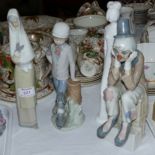 A Nao figure: boy with dog; 2 similar figures: seated clown and girl with rabbit; a Spode figure: