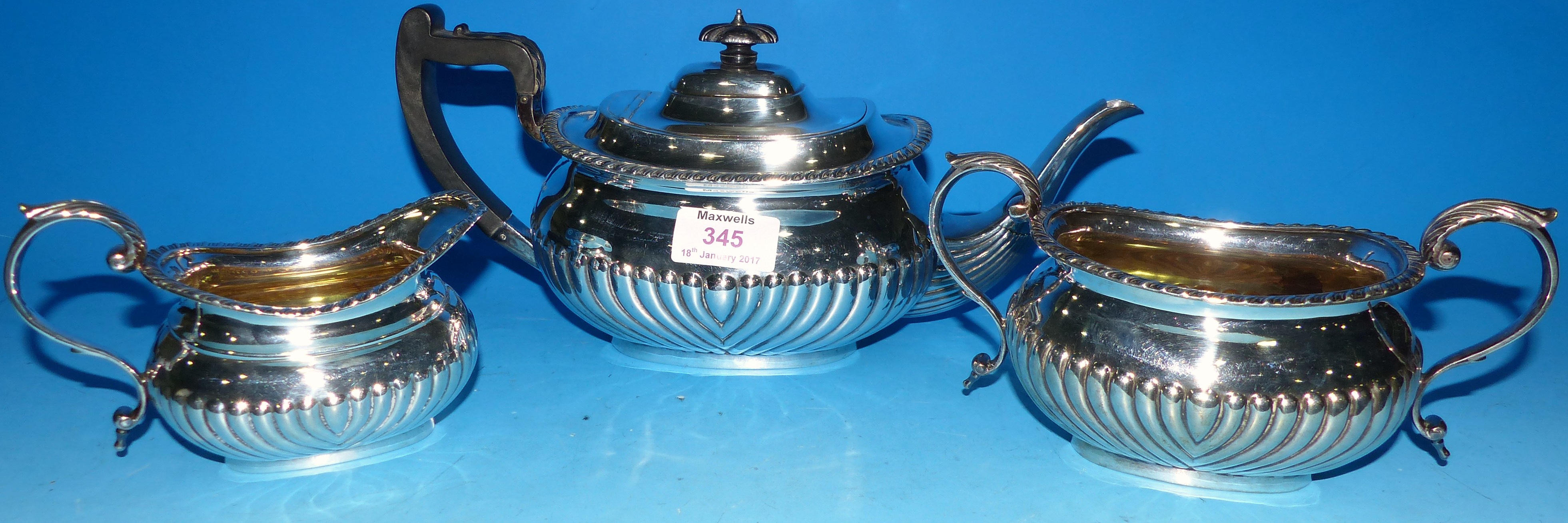 An antique silver 3 piece tea service of Regency boat shaped form with ebony handles, Sheffield