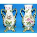 A pair of 19th century rococo style baluster vases with entwined scroll handles, decorated with