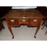 An 18th century oak lowboy with 3 frieze drawers, shaped apron and club legs, width 36½"