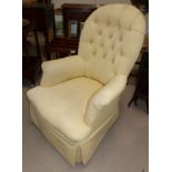 A Victorian walnut spoon back nursing chair on turned legs and castors upholstered in buttoned