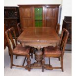 A carved oak ding table and 4 chairs, on bulbous legs with sideboard of one central glazed door