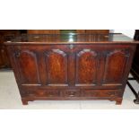 An 18th century oak mule chest with 4 raised and fielded ogee panels, 3 drawers and block feet,