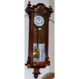 A 19th century walnut cased Vienna Regulator with white enamel dial and double weight driven