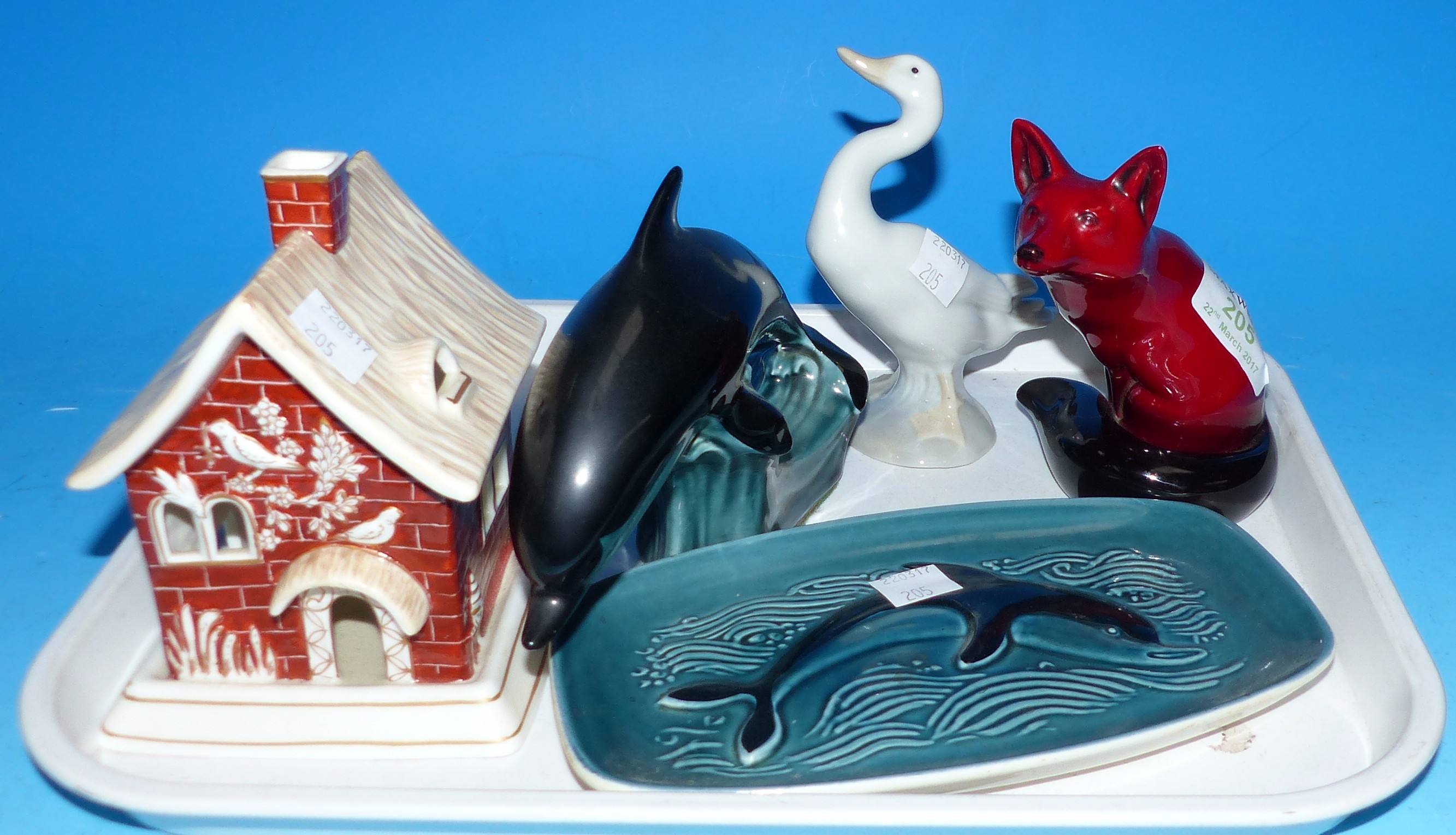 A Royal Doulton flambé ware fox; a Poole Dolphin; etc.