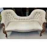 A Victorian walnut double spoon back settee with acanthus carved decoration, knurled feet and