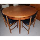 A 1970's G-Plan style dining suite comprising extending circular dining table and 4 chairs