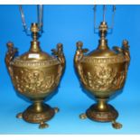 A pair of gilt bronze table lamps, classical urn shaped with winged female mounts and relief