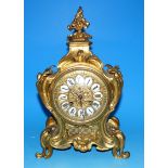 A 19th century ormolu mantel clock in rococo case, with scrolls, acanthus, etc., white enamel