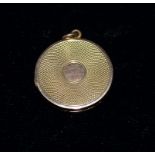 A 9 carat hallmarked gold engine turned circular locket, 5.7 gm